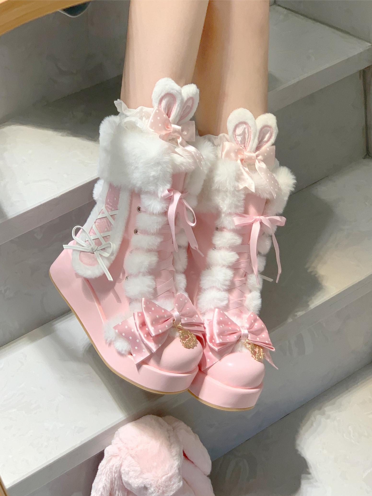Pink bunny boots with white fur on a light background