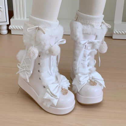 White winter boots with pom-poms and decorative elements on a wooden floor.