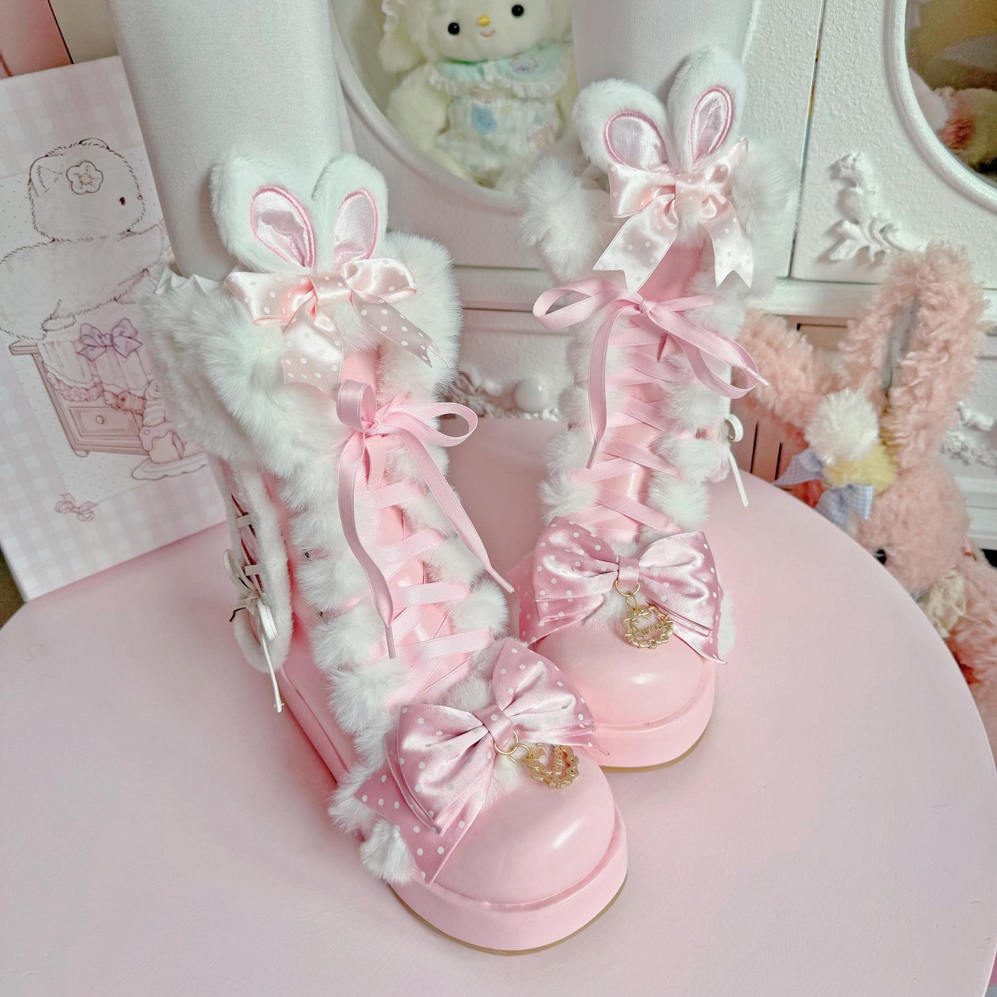 Pink and white bunny-themed shoes with decorative bows on a pink surface.