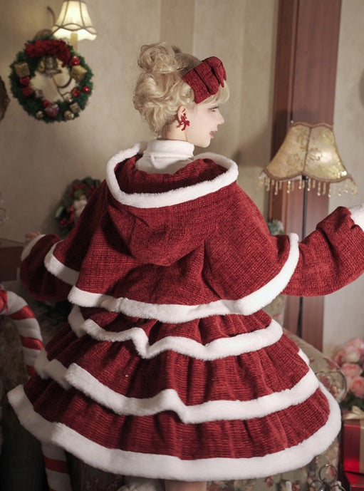 Mannequin wearing a red and white dress with a Christmas wreath in the background