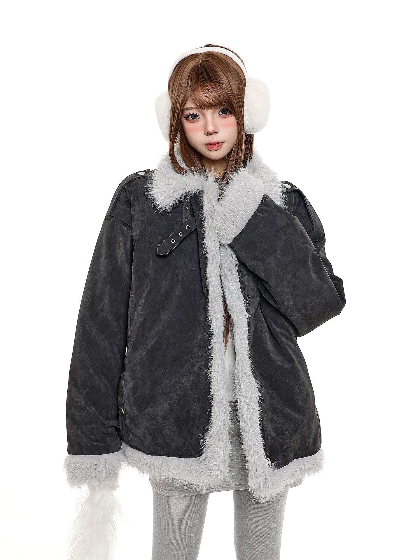 Person wearing a dark gray coat with white fur trim and matching white earmuffs on a white background