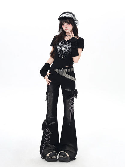 Person wearing a black outfit with graphic designs on a white background