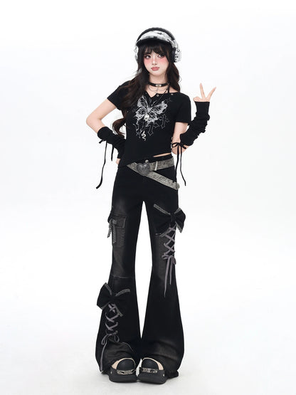 Person wearing a black outfit with lace-up details on a white background