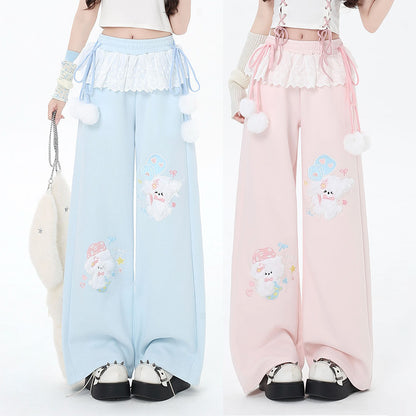 Two pairs of pastel-colored pants with cloud designs on a white background