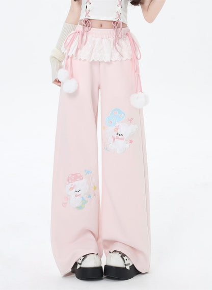 Pink pants with cartoon character design worn by a person on a white background