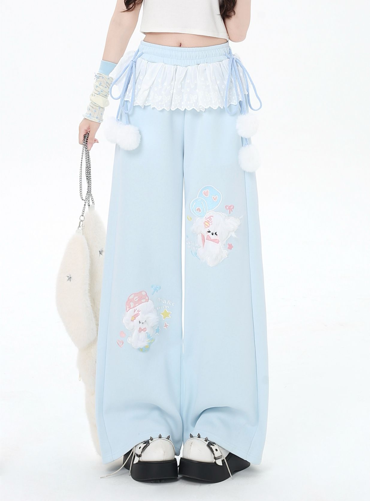 Light blue pants with cartoon character design worn by a person on a white background