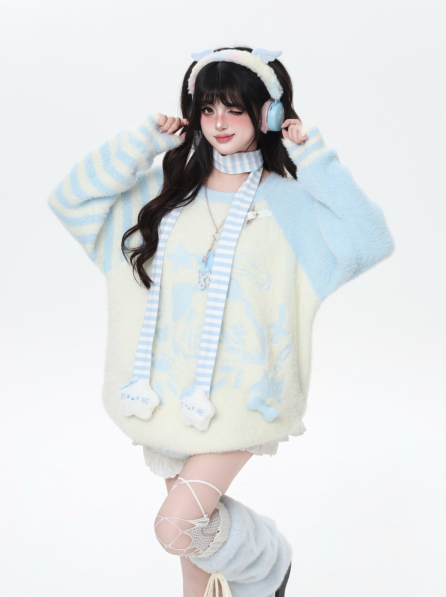 Person wearing a light-colored outfit with striped sleeves and headphones on a white background