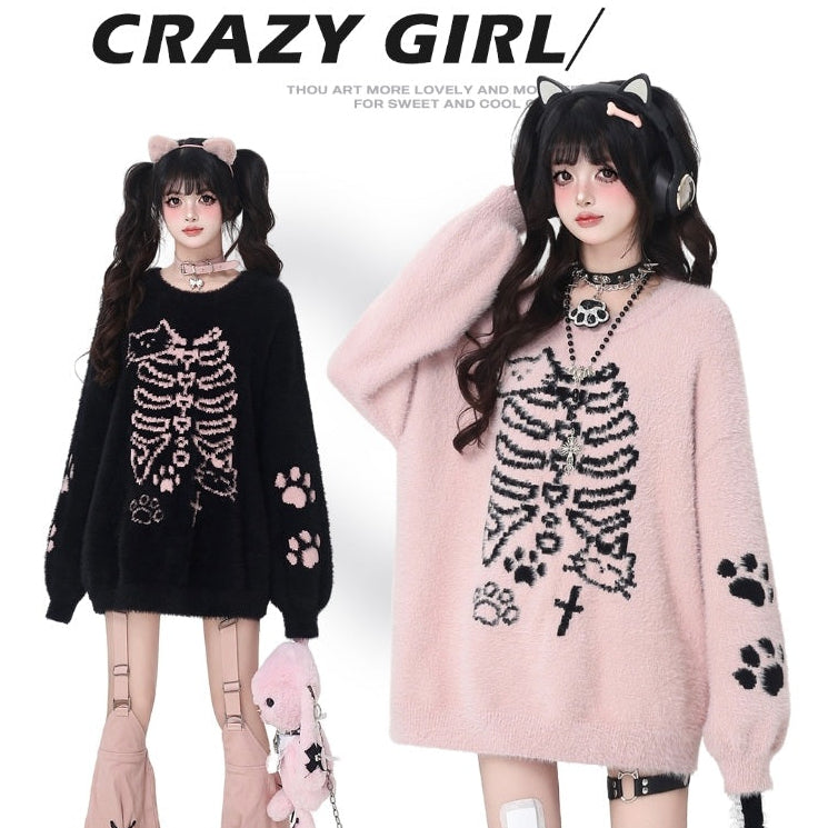 Two models wearing skeleton-themed sweaters with paw prints, standing side by side against a white background.