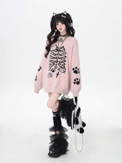Person wearing a pink sweater with black paw print design on a white background