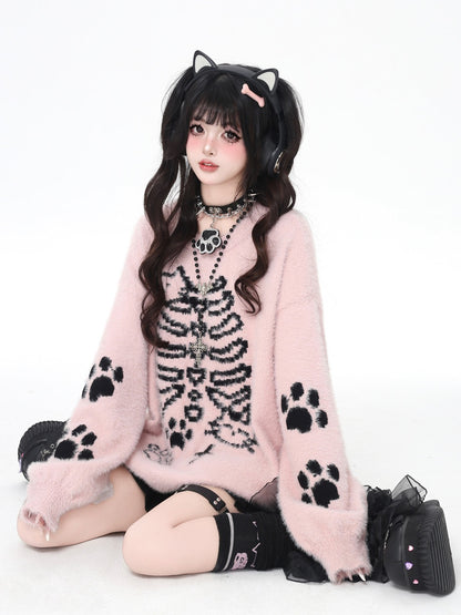 Person wearing a pink sweater with black paw prints and cat ears on a white background