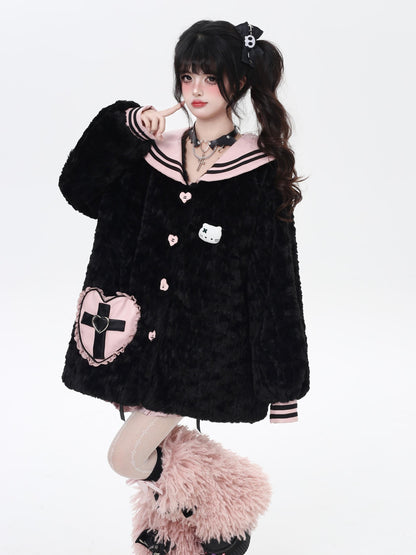 Person wearing a black plush jacket with heart and cross designs on a white background