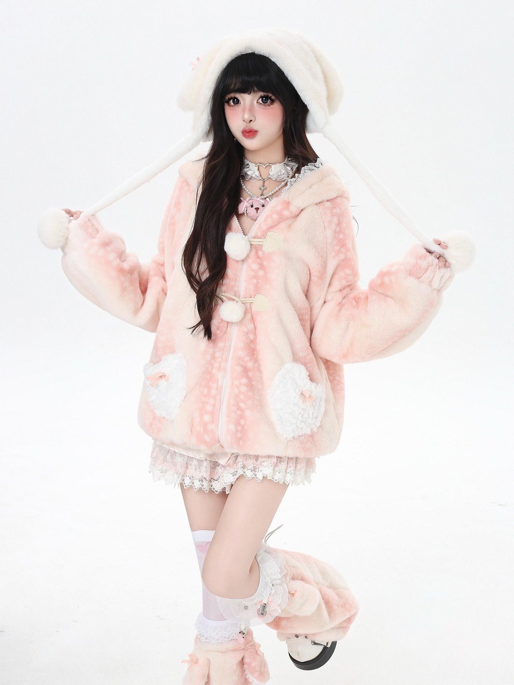 Person wearing a pink fluffy deer outfit with white accents on a white background
