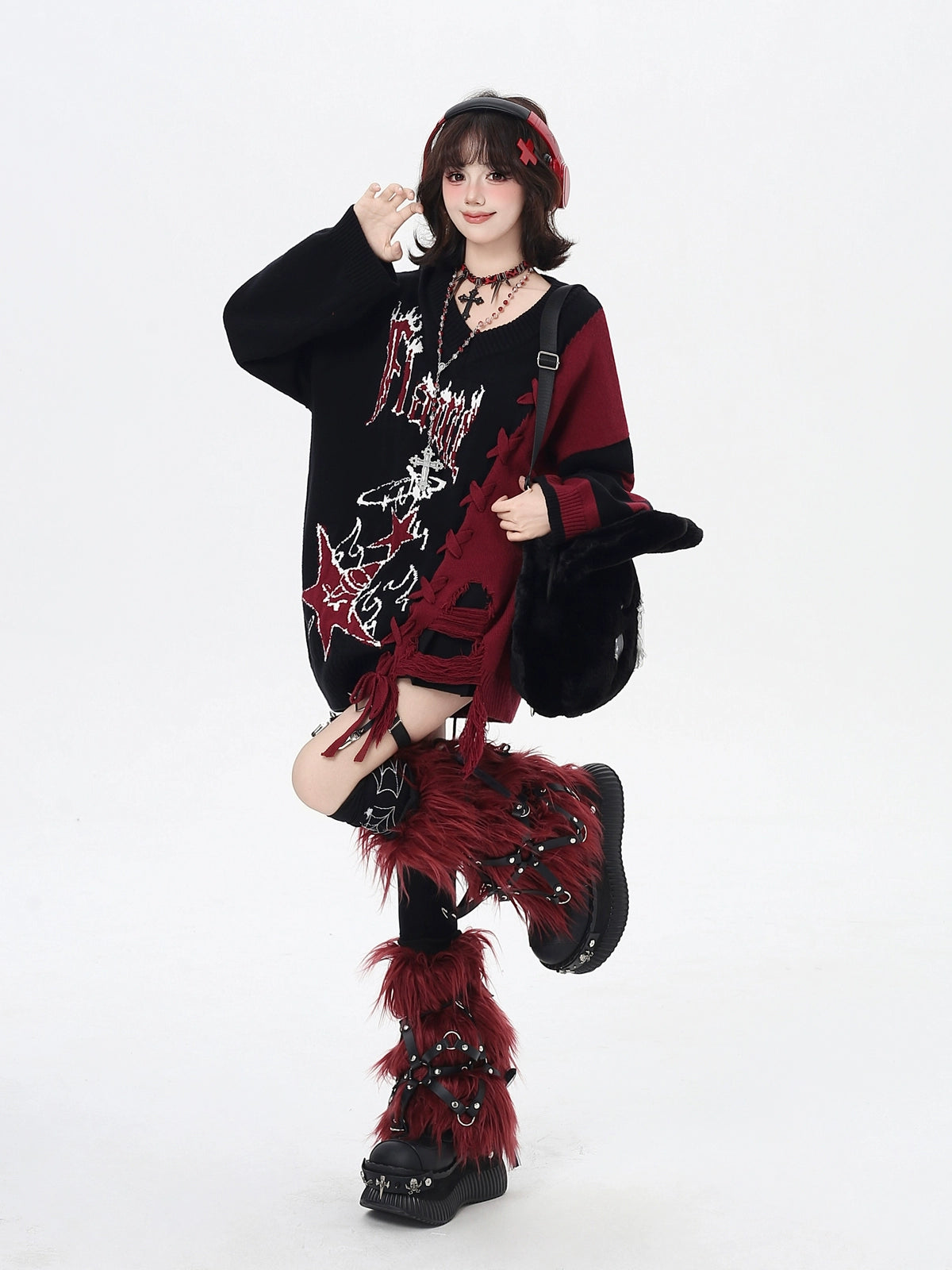 Person wearing a black and red outfit with feathered boots on a white background