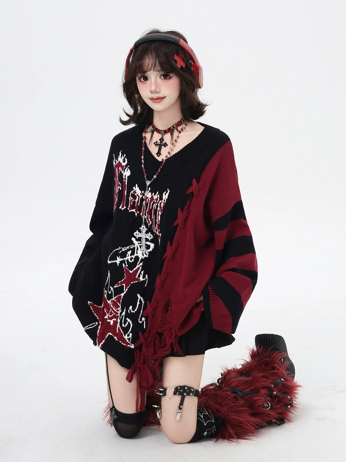 Person wearing a black and red outfit with decorative elements on a white background