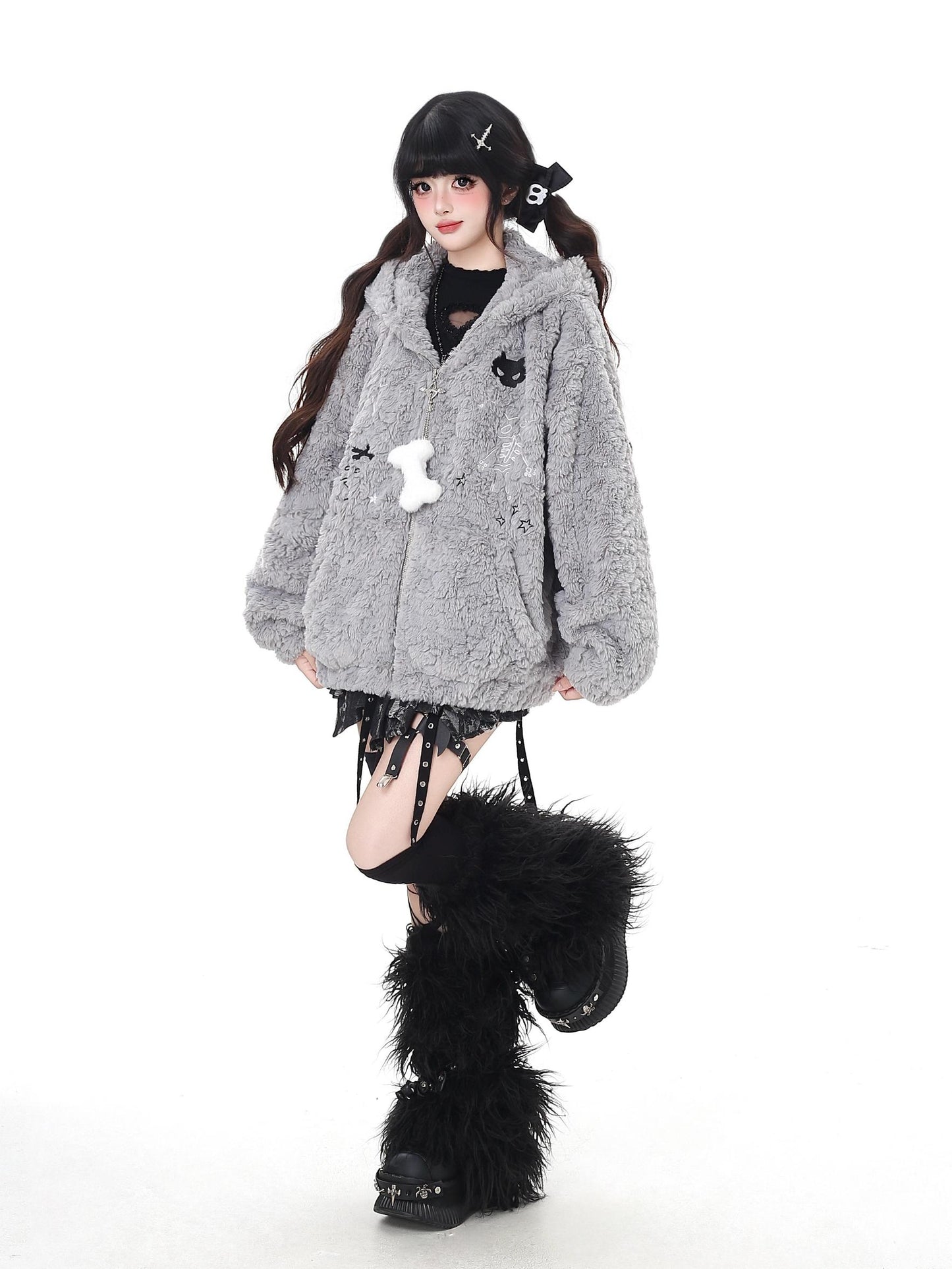 Person wearing a gray oversized coat with decorative elements on a white background