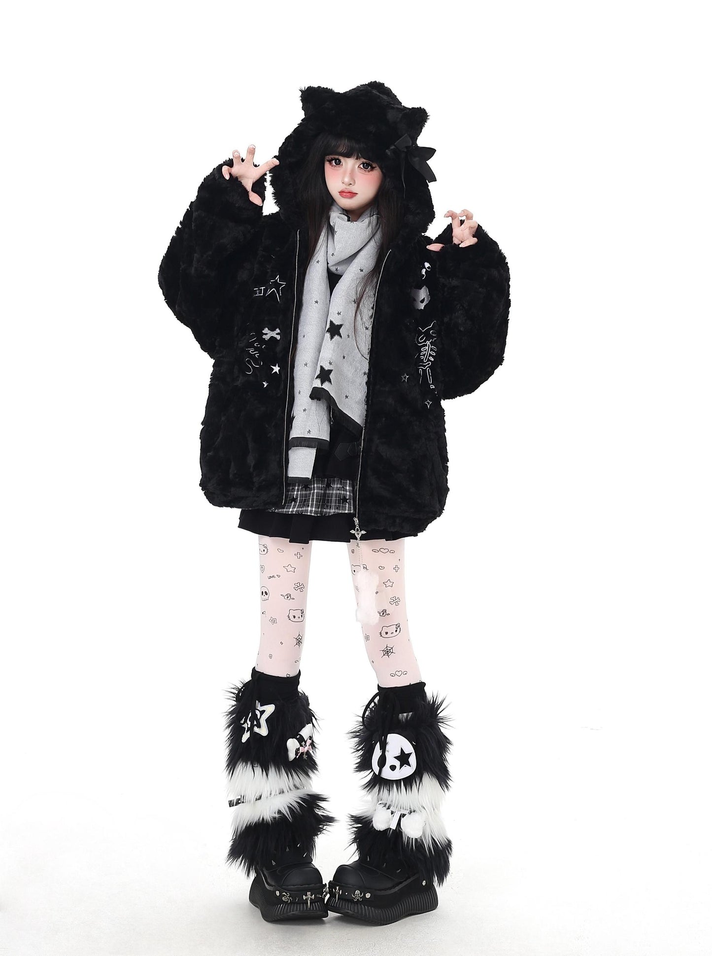 Person wearing a black fur-lined coat with star patterns on a white background