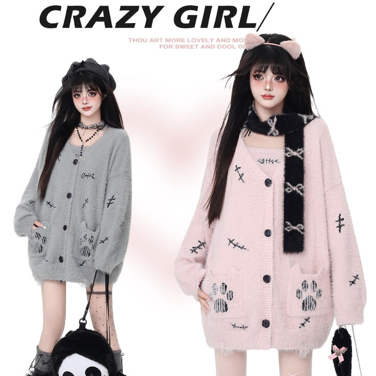 Two people wearing cardigans with cat-themed designs, one gray and one pink, on a white background.