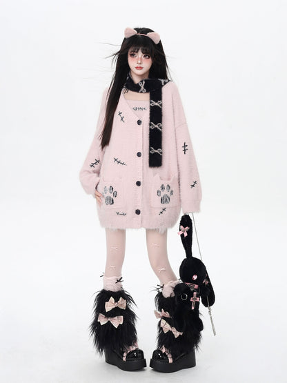 Person wearing a pink outfit with black accents and cat ears on a white background