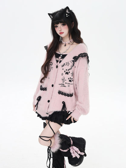 Person wearing a pink cardigan with black accents and cat ears on a white background