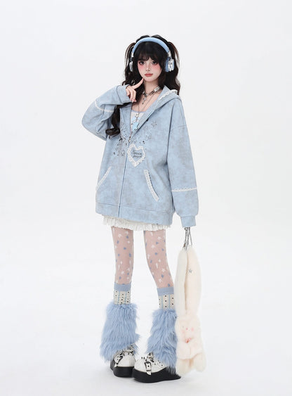 Person wearing a light blue hoodie with decorative elements, white tights, and fluffy boots on a white background