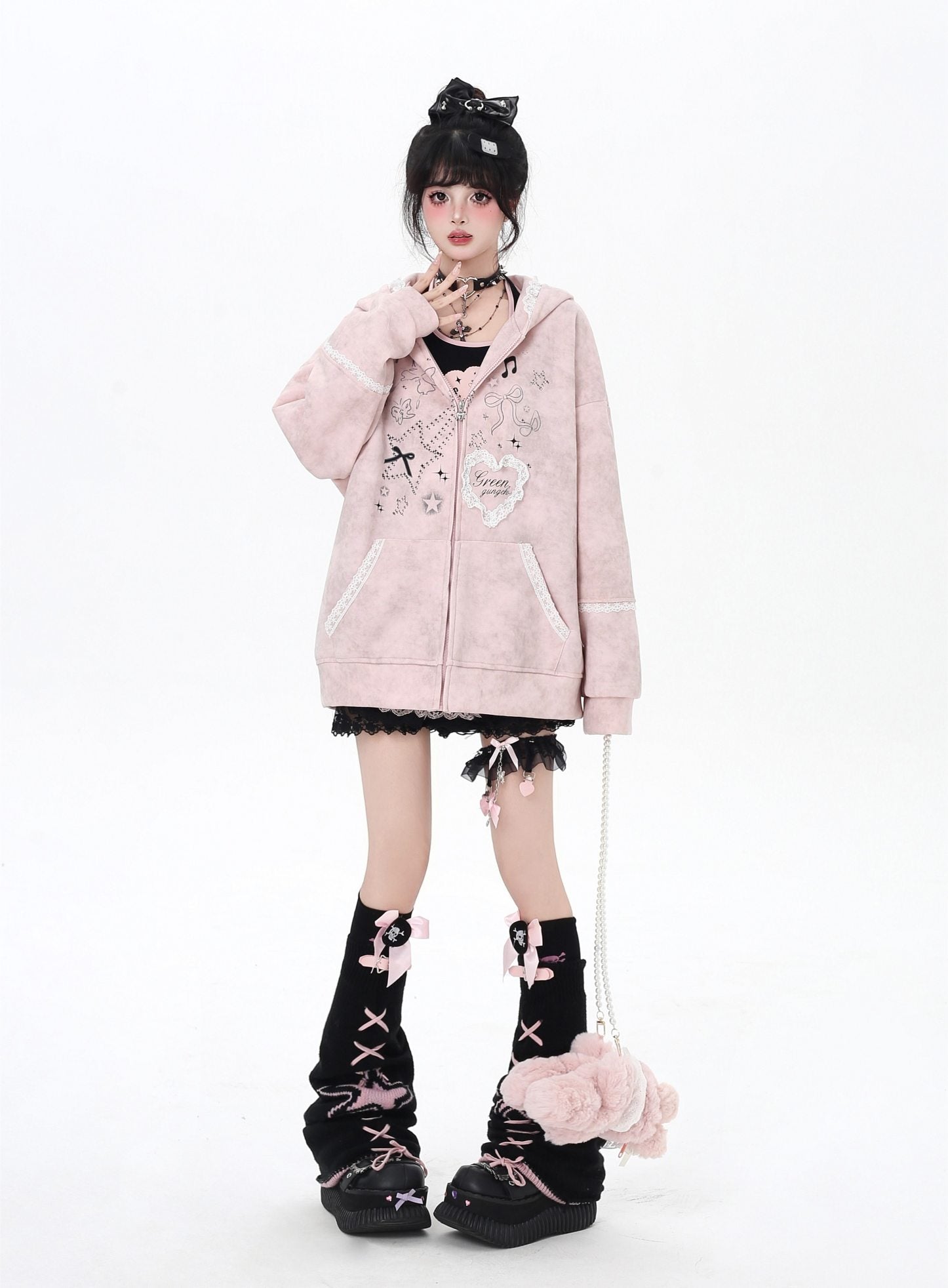 Person wearing a pink hoodie with decorative elements on a white background