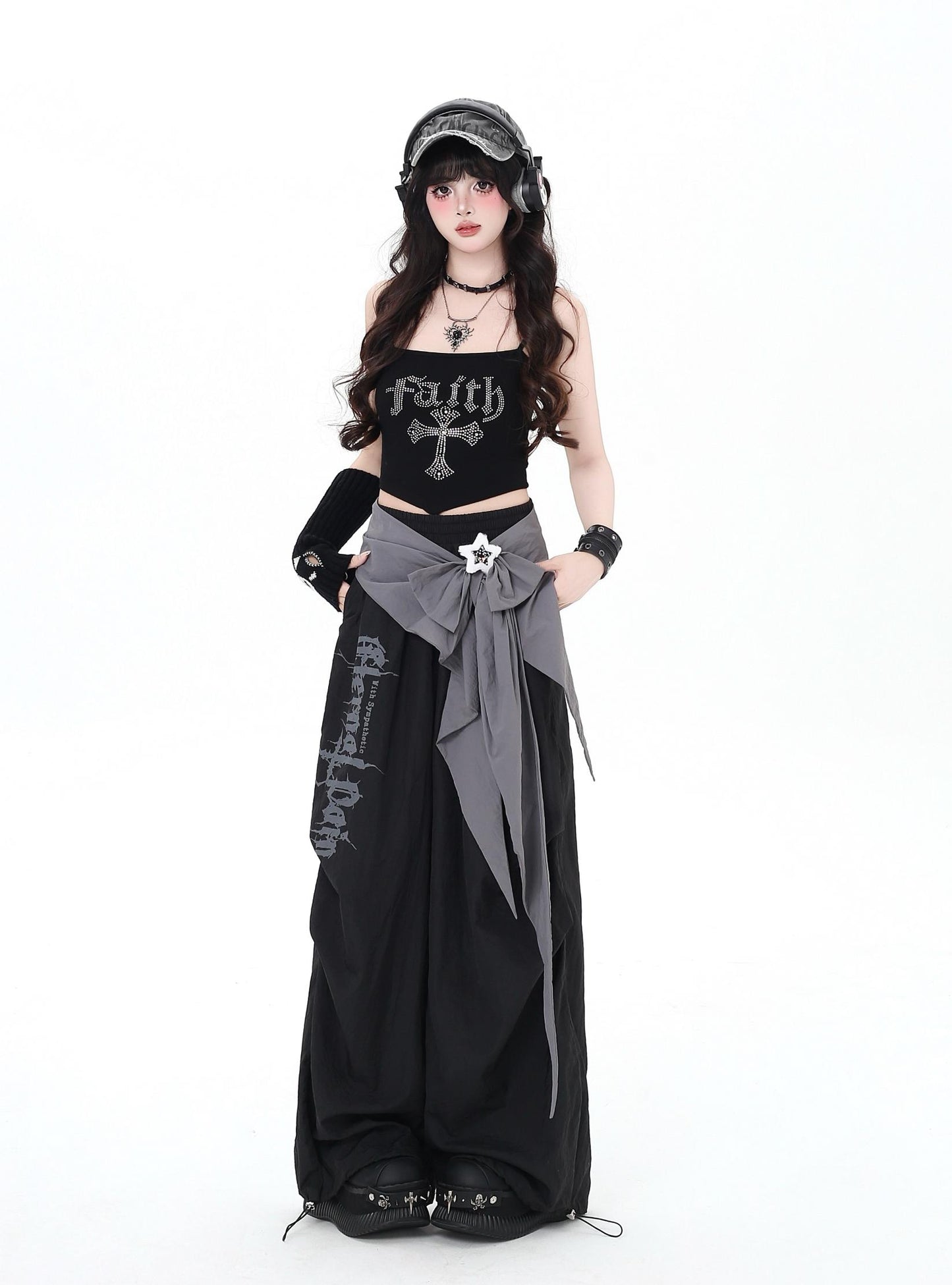 Person wearing a black and gray outfit with 'Faith' text on a white background