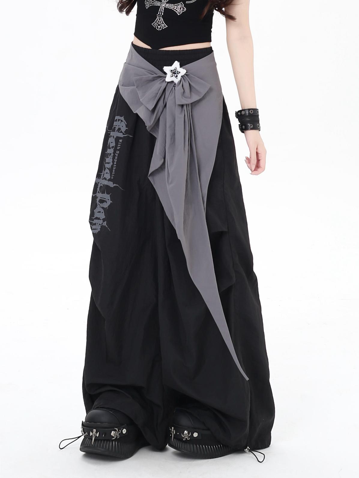 Person wearing a black and gray pants with a white star detail on a white background