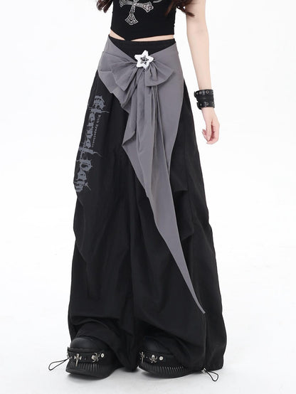 Person wearing a black and gray pants with a white star detail on a white background