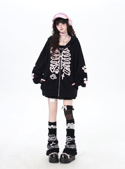 Person wearing a black skeleton hoodie with white accents on a white background