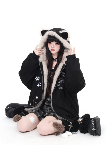 Person wearing a black hoodie with cat ears and paw prints on a white background