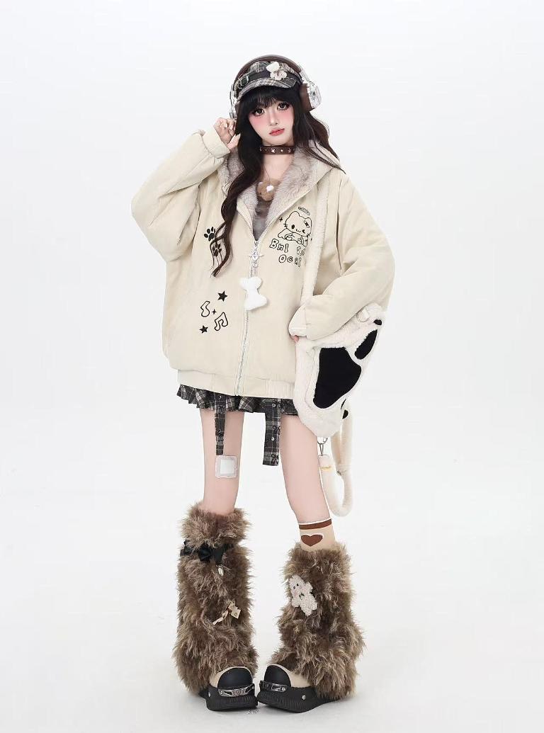 Person wearing a cream-colored hoodie with cartoon designs, black skirt, and brown furry boots on a white background