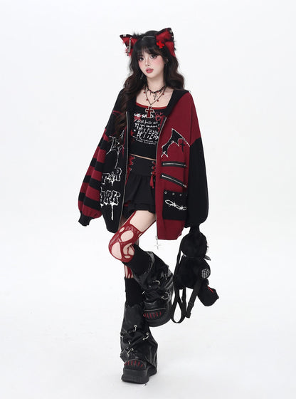 Person wearing a gothic-inspired outfit with a red and black jacket on a white background