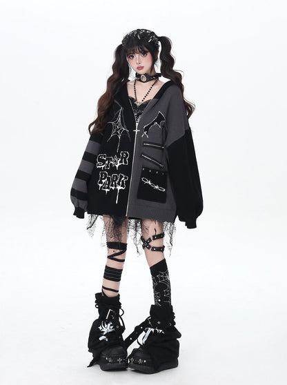 Person wearing a black and gray jacket with gothic accessories on a white background