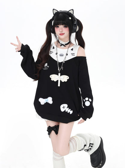 Person wearing a black and white cat-themed outfit with cat ears on a white background