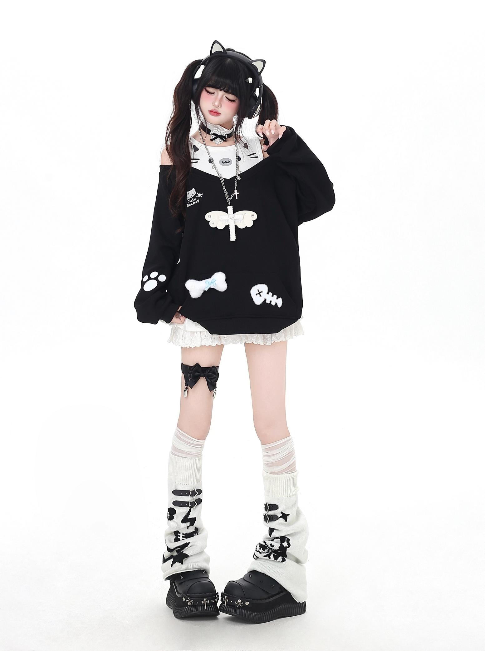Person wearing a black and white outfit with cat-themed design on a white background