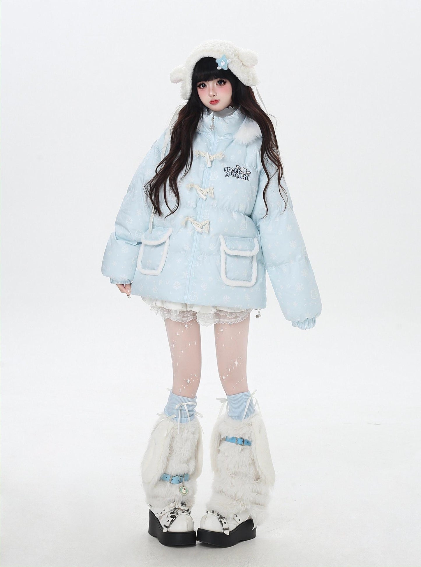 Person wearing a light blue winter coat with white fur trim on a white background