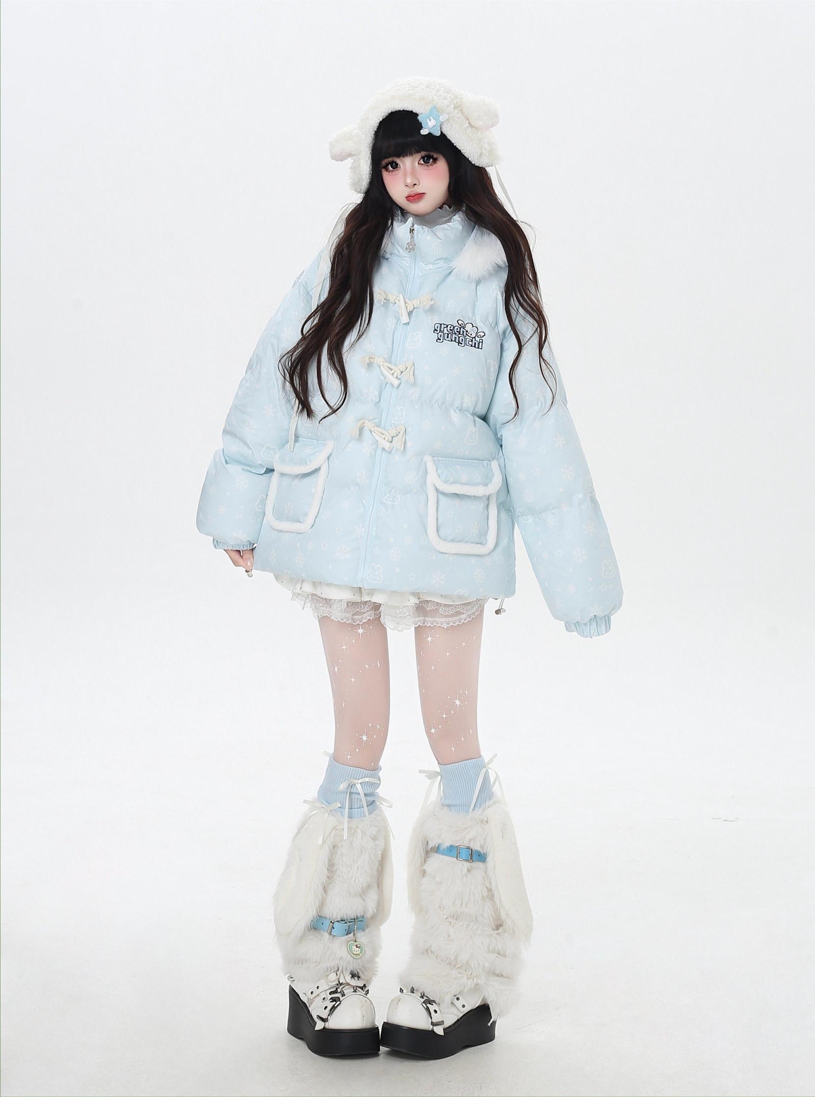 Person wearing a light blue winter coat with white fur trim on a white background