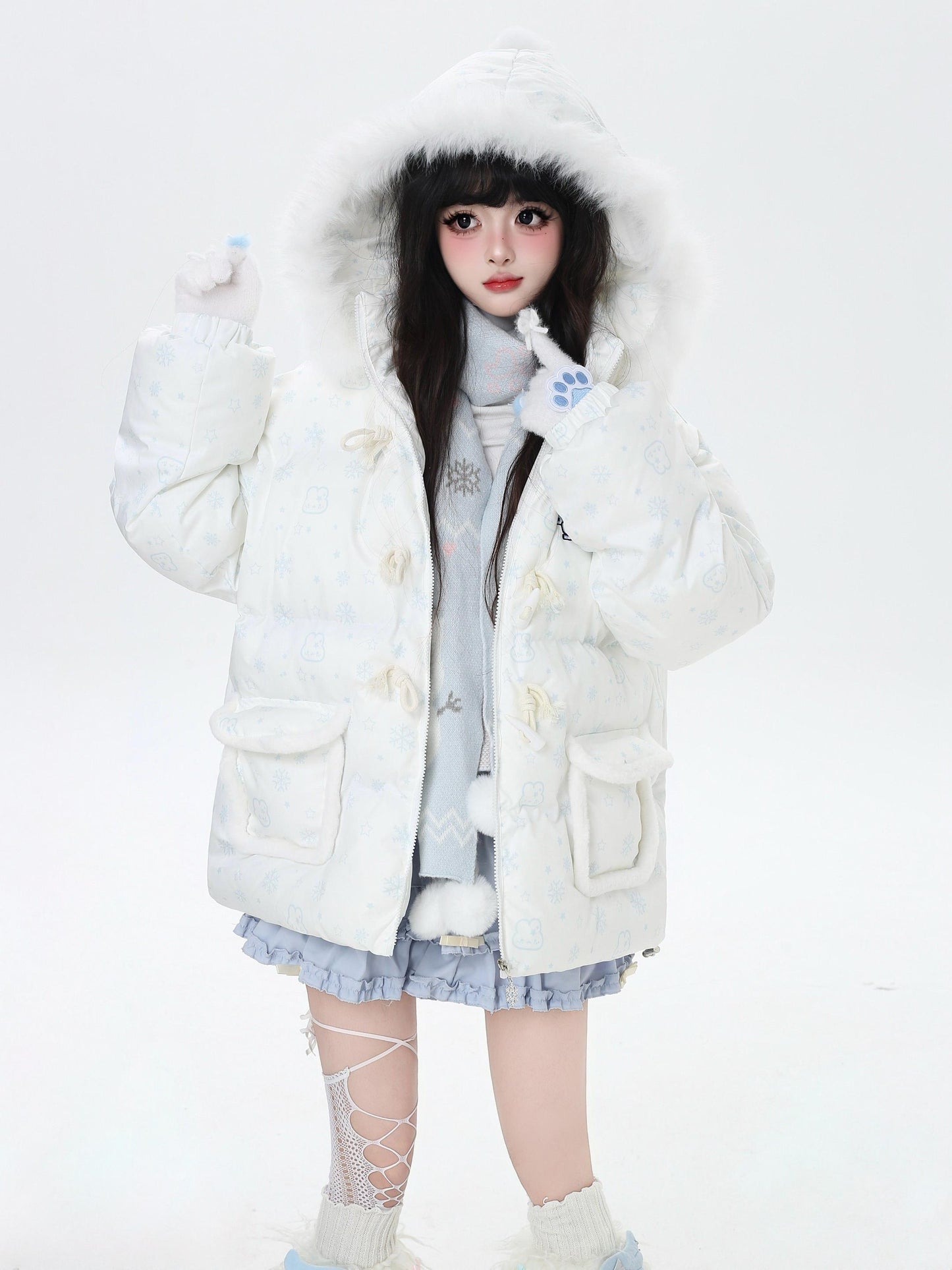 Person wearing a white fluffy coat with a hood on a white background