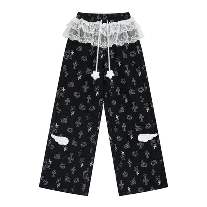 Black pants with white lace trim and decorative elements on a white background