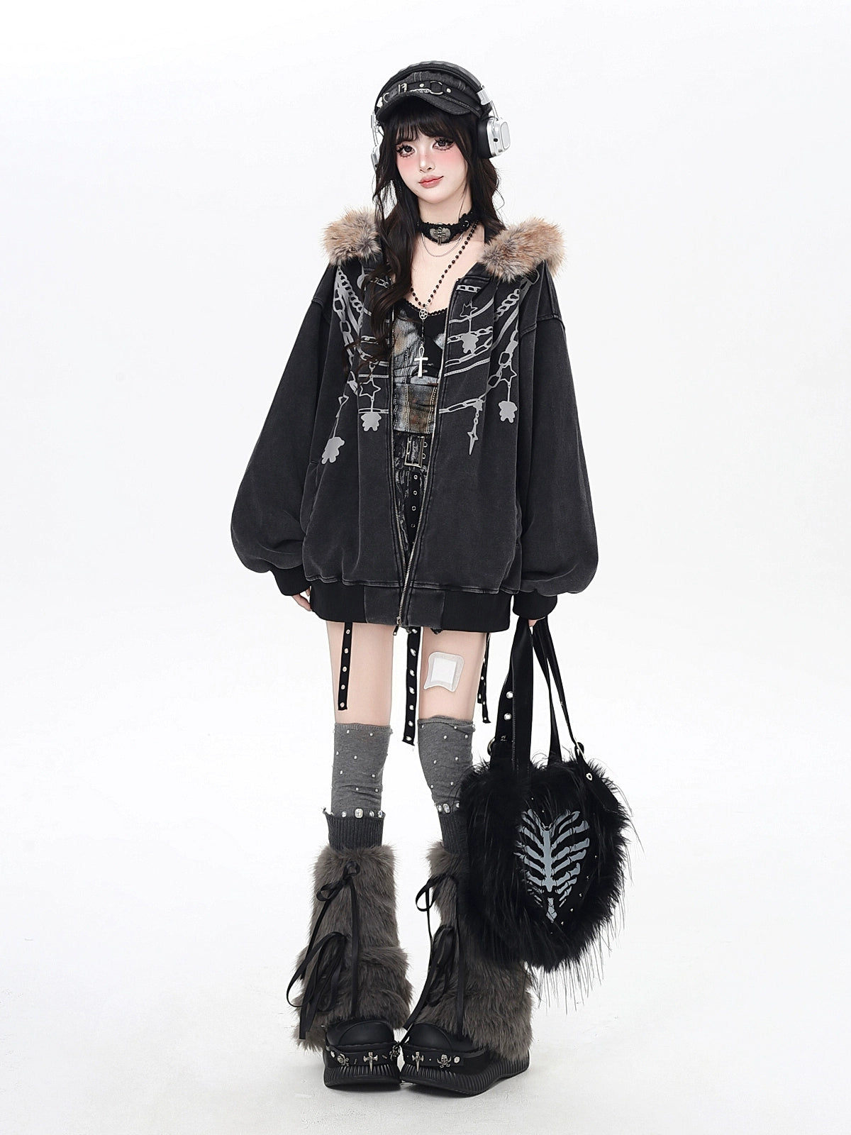 Person wearing a black outfit with fur accents and a helmet on a white background