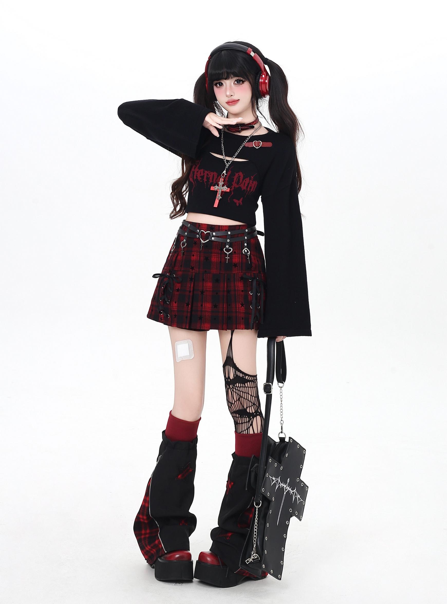 Person wearing a gothic outfit with a plaid skirt, black top, and red accents on a white background.