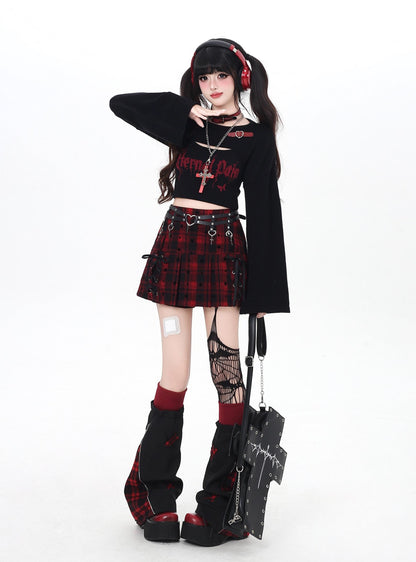 Person wearing a gothic outfit with a plaid skirt, black top, and red accents on a white background.