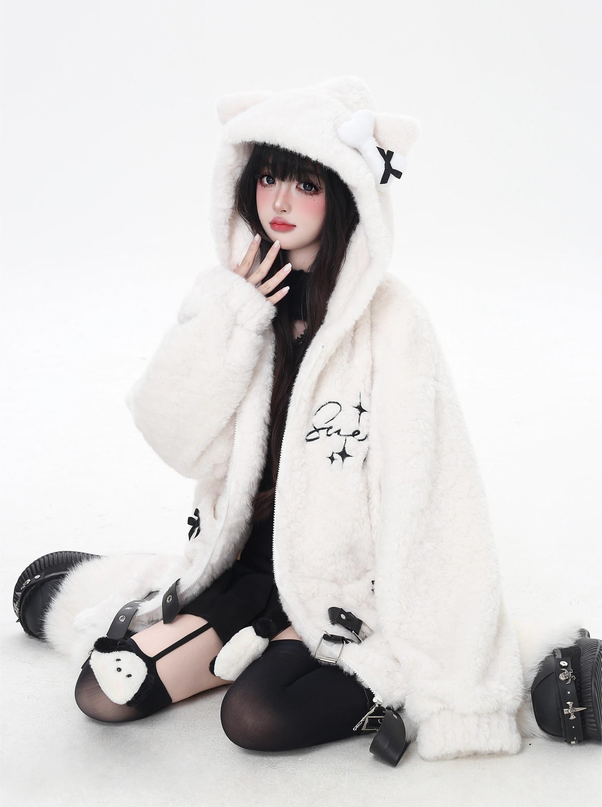 Person wearing a white fur coat with a hood on a white background
