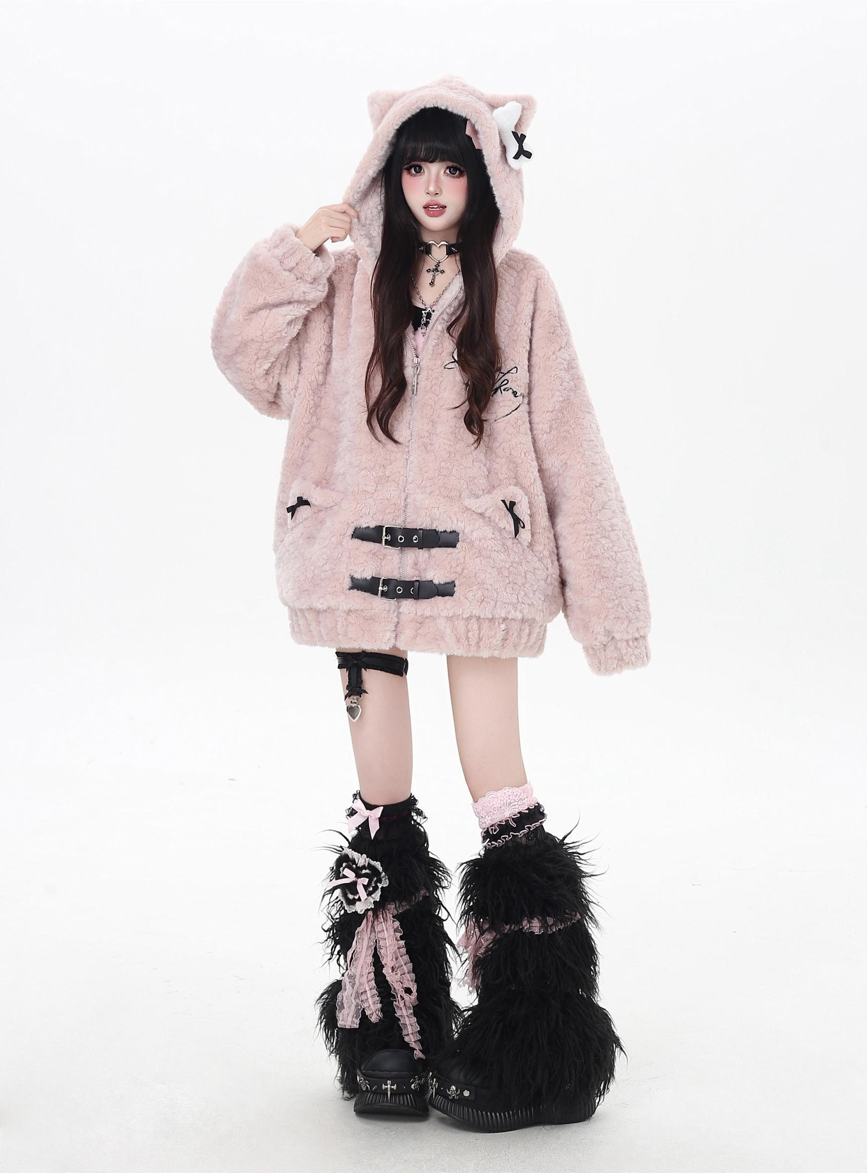 Person wearing a fluffy pink hoodie with cat ears on a white background