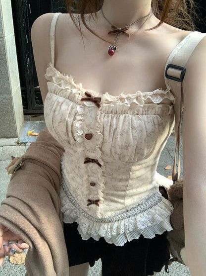 Person wearing a beige lace top with buttons and a matching skirt.