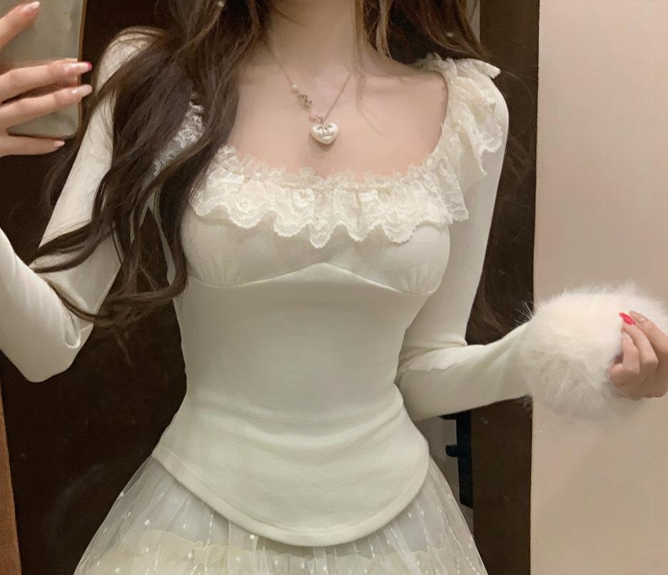 Person wearing a white lace top and skirt with a blurred background