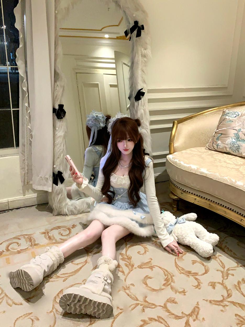 Person in a decorative room with a mirror and sofa