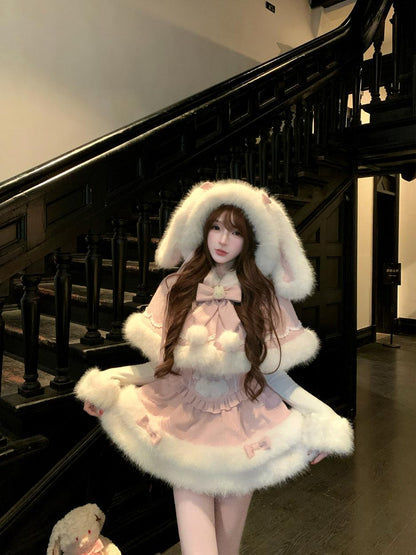 Person wearing a cute winter pink outfit with white fur trim in a staircase setting