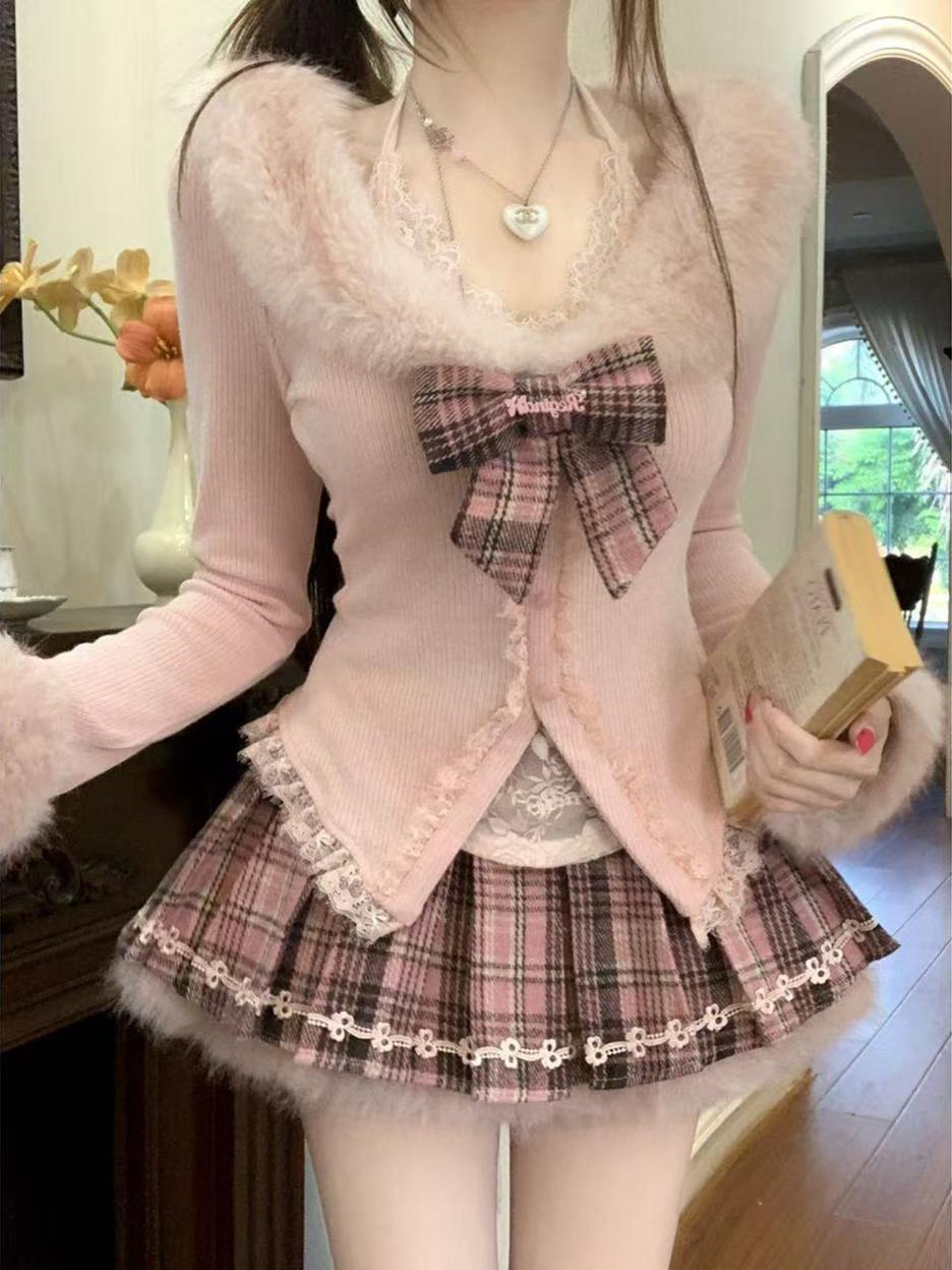 Person wearing a coquette winter pink outfit with a large bow and plaid skirt indoors.