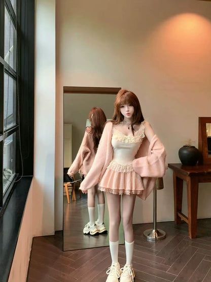 Woman in a coquette pink outfit standing in front of a mirror in a room.